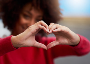 Cropped shot of an unrecognizable woman forming a heart shape with her fingers